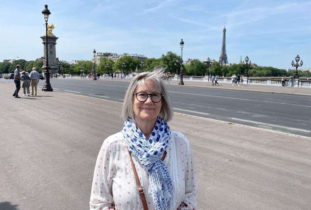 A photo of the author Marty Almquist in Paris, France with the Eiffel Tower visible in the background.