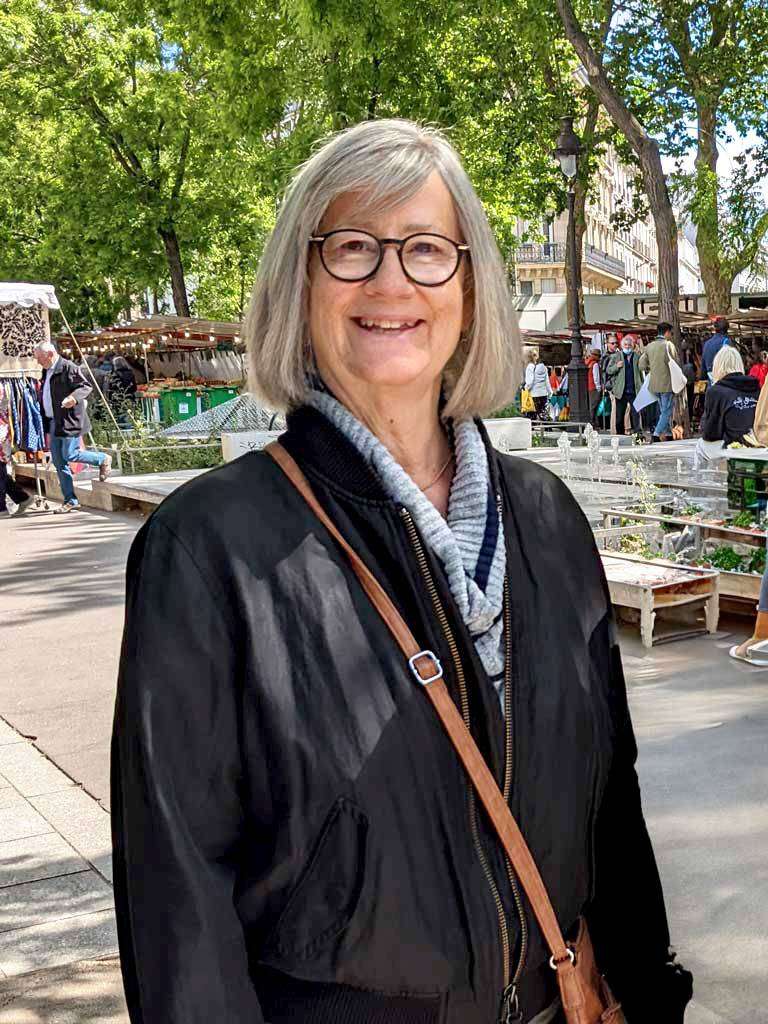 A photo of the author Marty Alquist as she explores the streets of Paris, France.